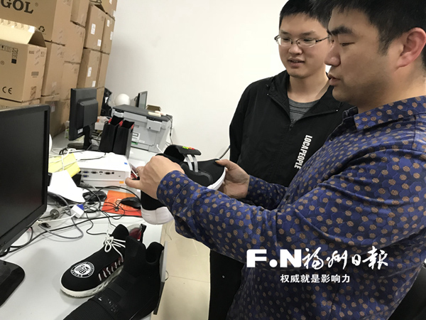 陈俊和学生们在探讨如何完善自动绑带鞋。